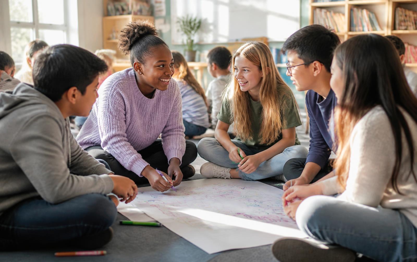 Students sitting in a circle in lively discussion and collaborative work